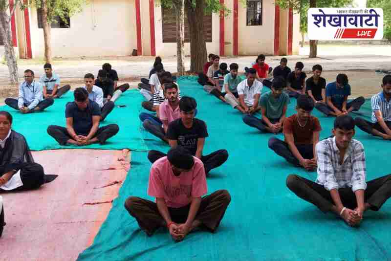 Students and staff performing yoga at SMTI Bagad on Yoga Day