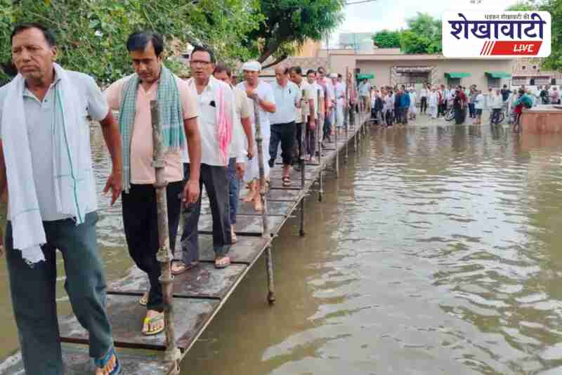 Temporary bridge built during rain for funeral procession in Sujangarh