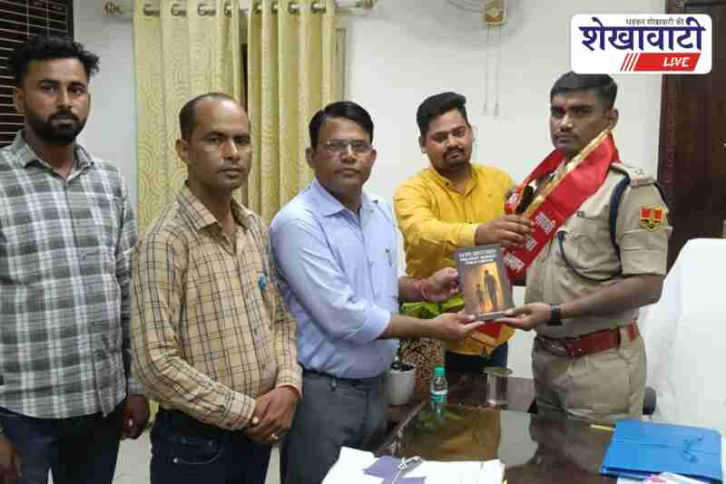 Activists present Hope Restored book to Sikar SP against child labour